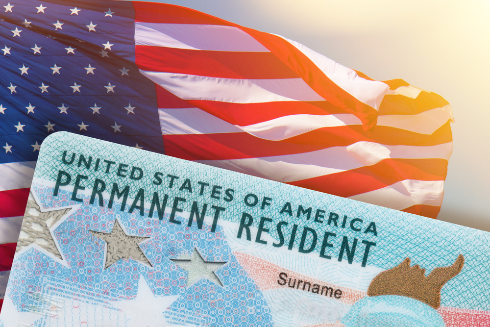 Green Card US Permanent Resident Card Diversity Electronic Visa DV-2022 Lottery Results. United States of America. American flag background.